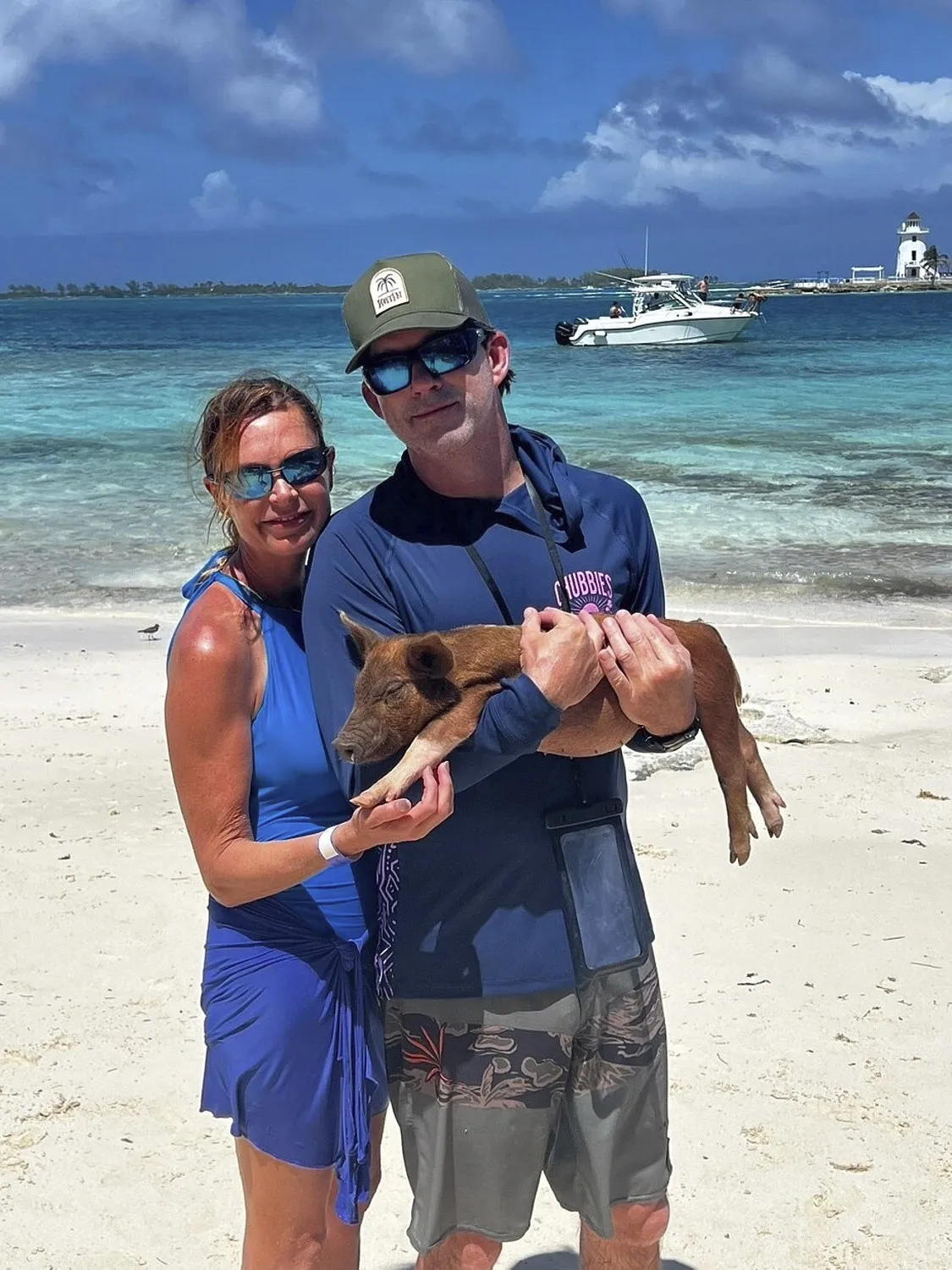 Couple holding a piglet
